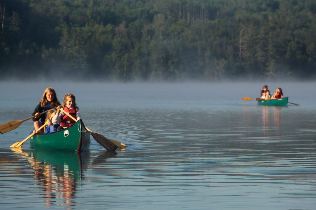 People canoeing on a lake.