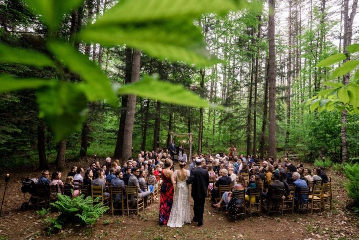A bride walking to the end of the aisle at an outdoor wedding.