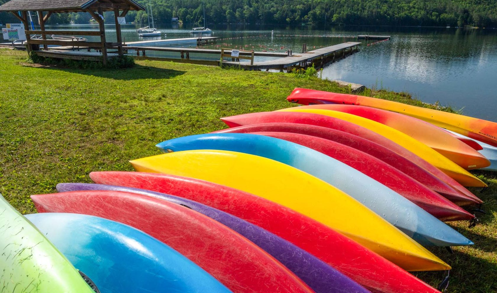 Colorful kayaks lined up in a row.