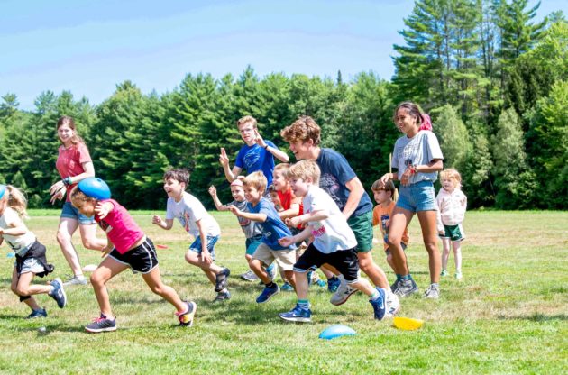 Horizons campers running on a field.