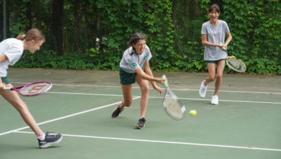 Campers playing tennis.