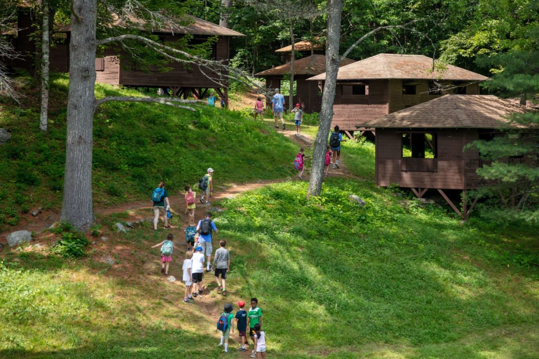 Campers walking up a hill.
