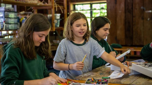 Campers drawing with crayons.