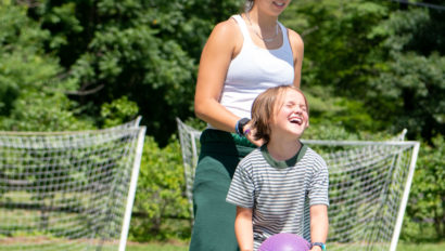 Smiling camper playing dodgeball.