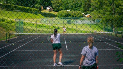 Campers playing tennis.