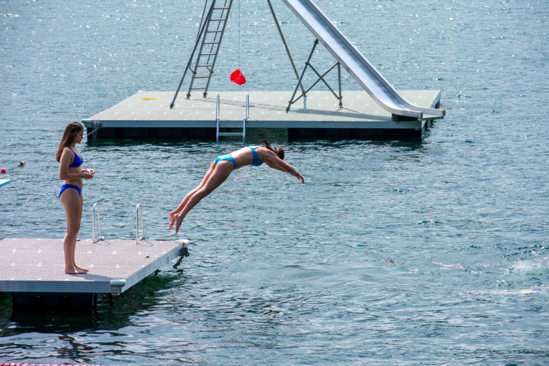 A camper diving into a lake.
