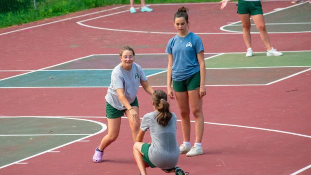Campers playing sports on a court.