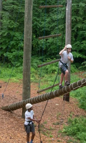 Campers doing a ropes course.