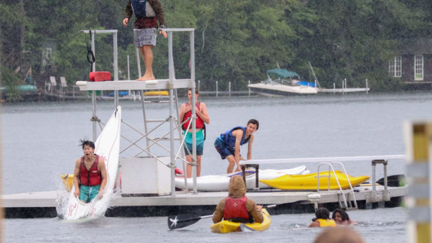 Campers with kayaks in the swim area.