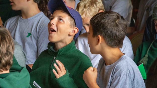 Campers singing during a camp assembly.