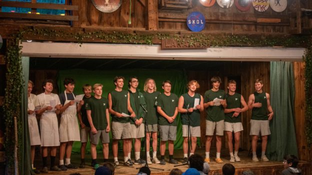 Bridgers singing for camp during an assembly.