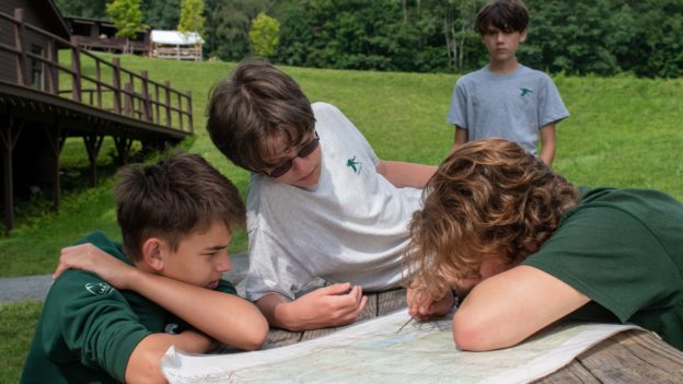 Campers looking at a map in campcraft.