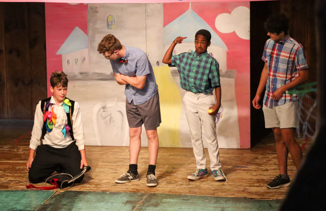 Four campers acting on stage.