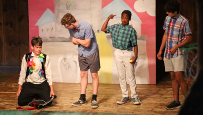 Four campers acting on stage.