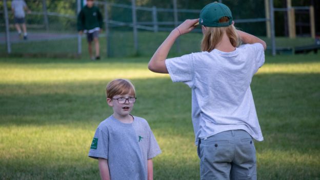 Two Lanakila campers chatting in a field.
