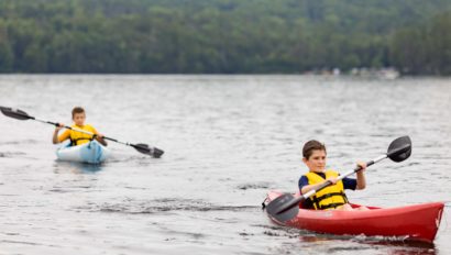 Two boys kayaking.