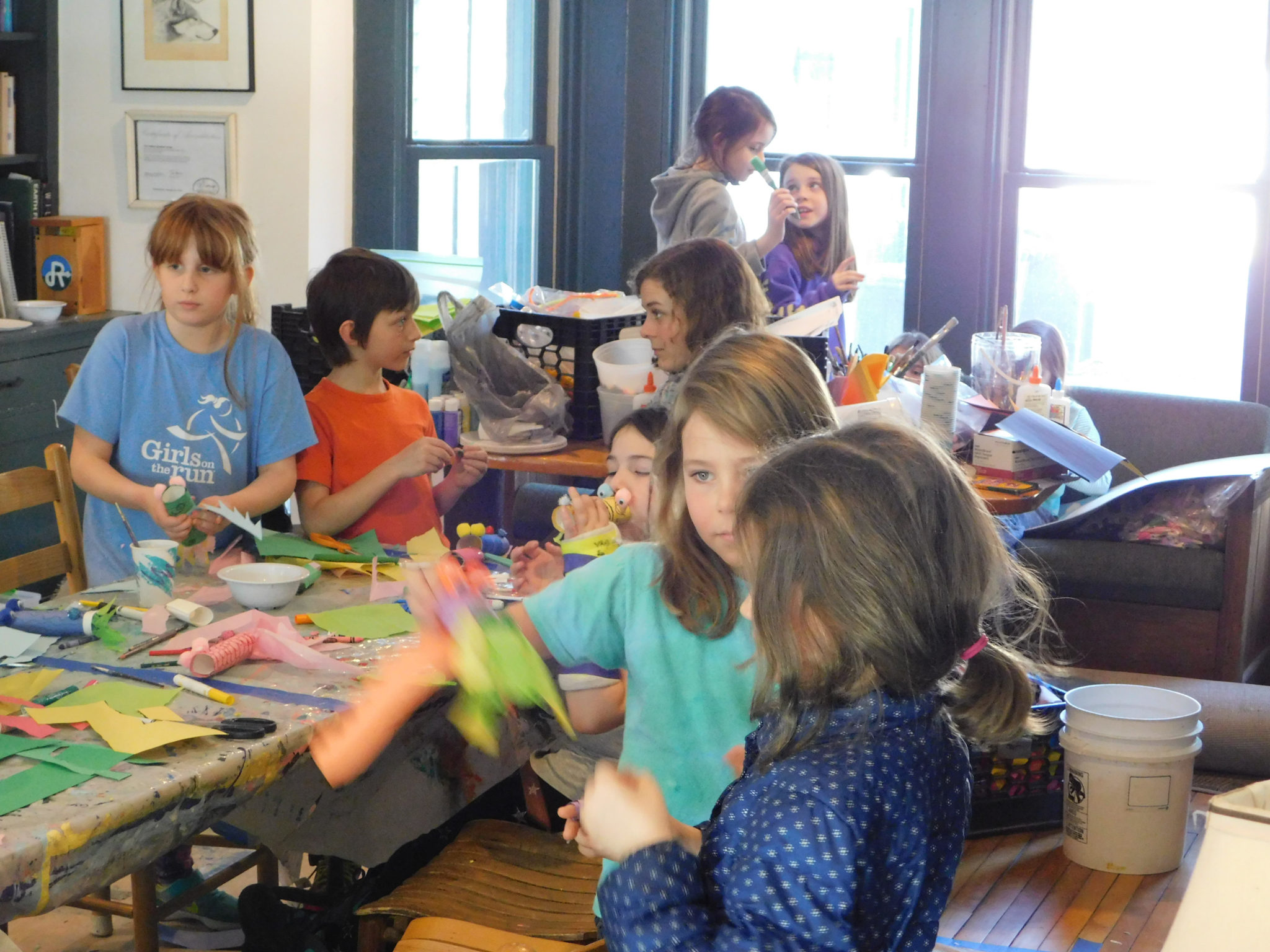 A group of children working on crafts in the Hulbert living room.
