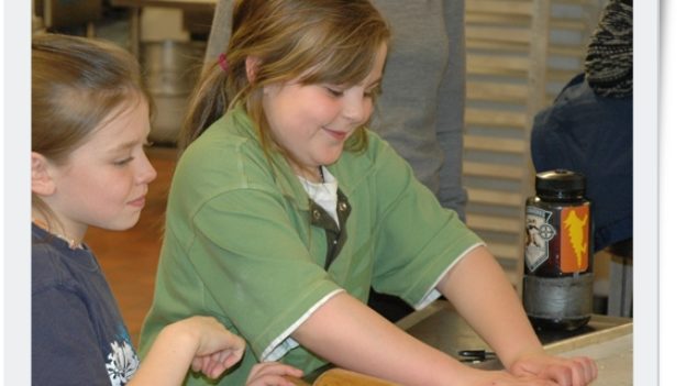 A girl kneading dough.