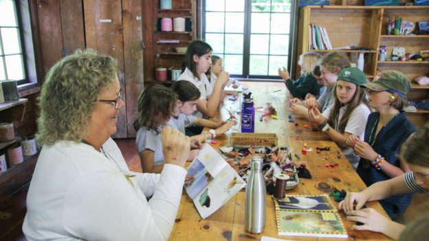 Campers working on arts and crafts.