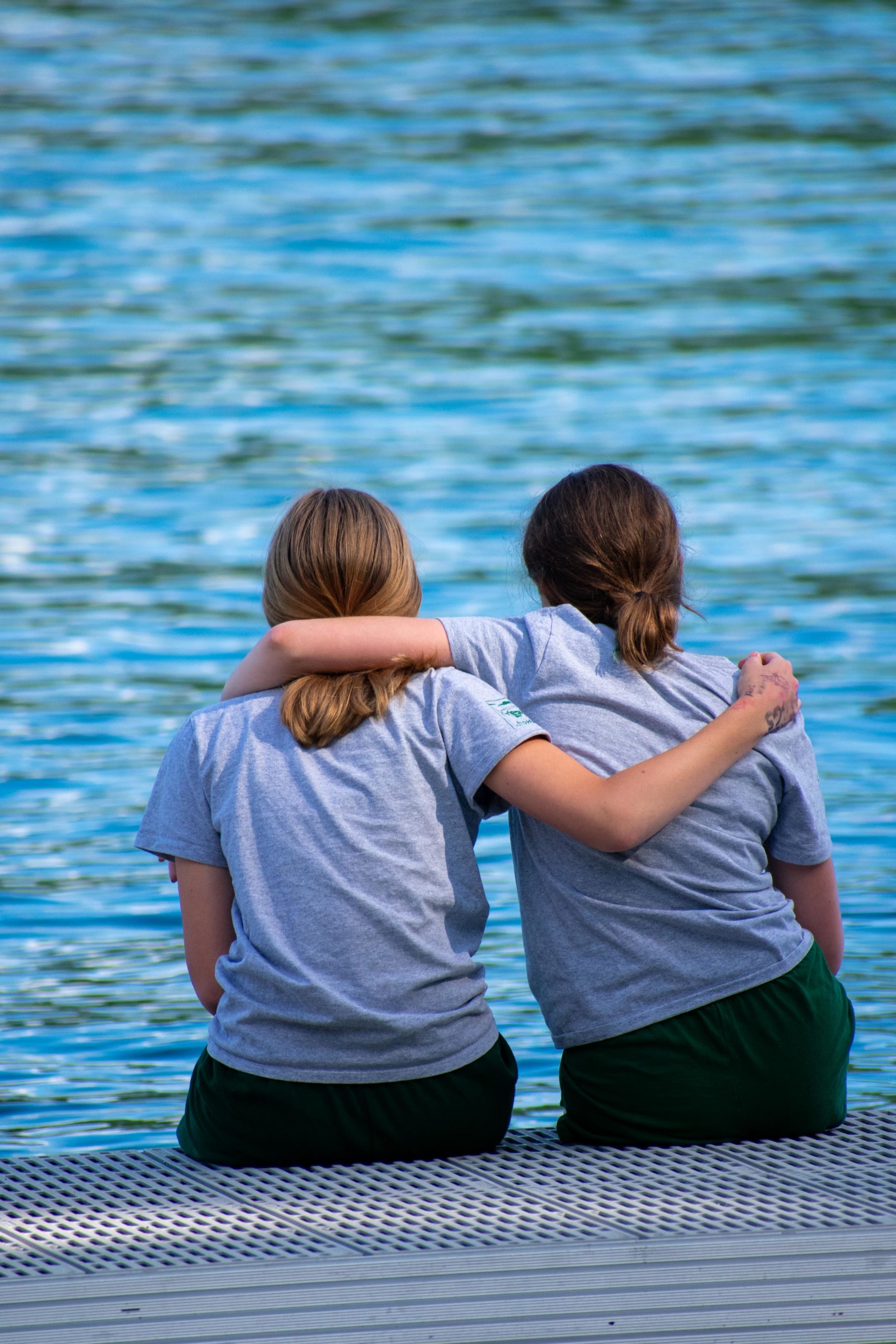 Campers hugging by the water.
