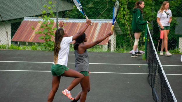 Aloha campers playing tennis.