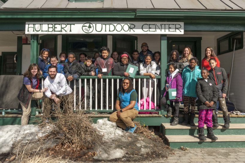 A school group and Hulbert staff gathered on the front porch of The Hulbert Outdoor Center.