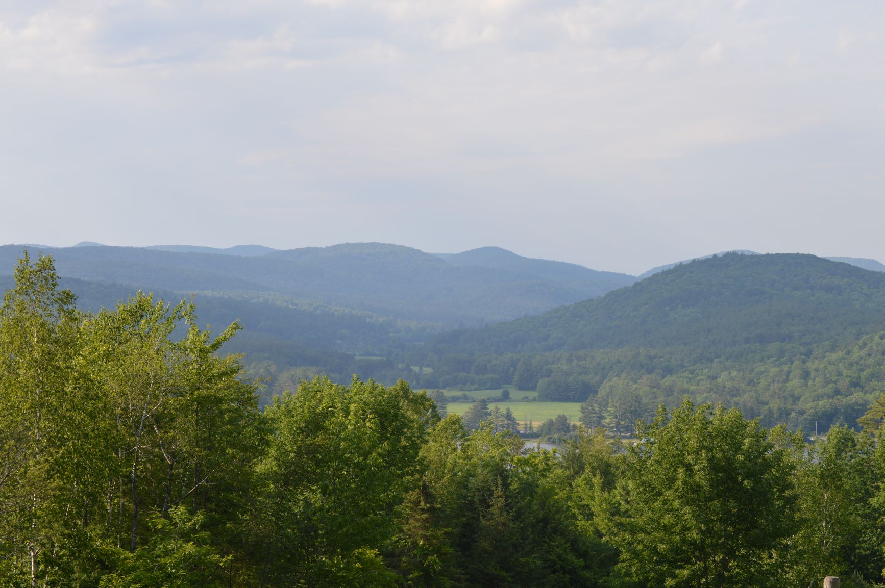 A lookout on top of a green mountain.