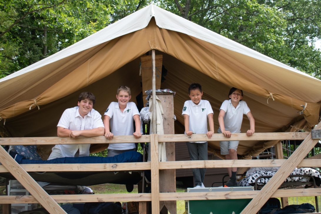 Four campers in an open air cabin.