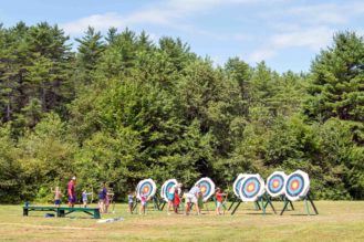 Campers learning archery.