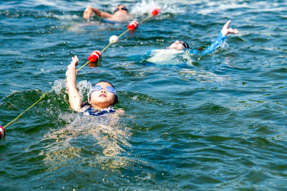 A child swimming backstroke.