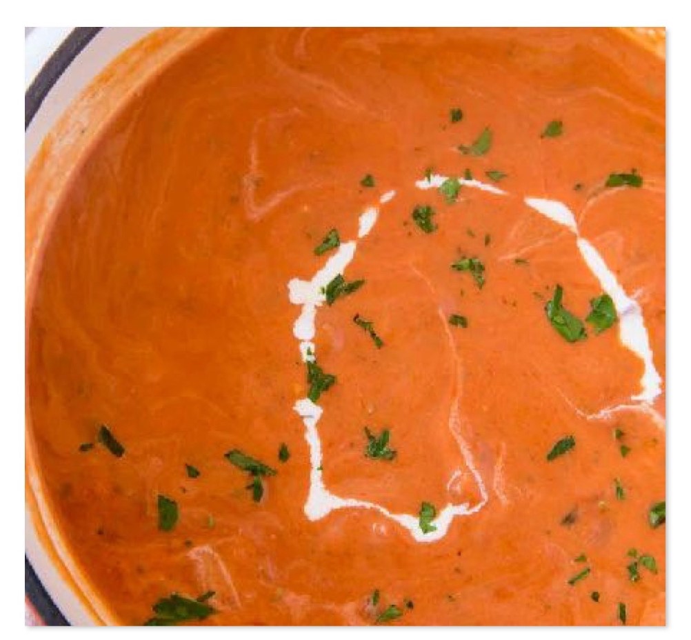 A zoomed in picture of tomato soup.