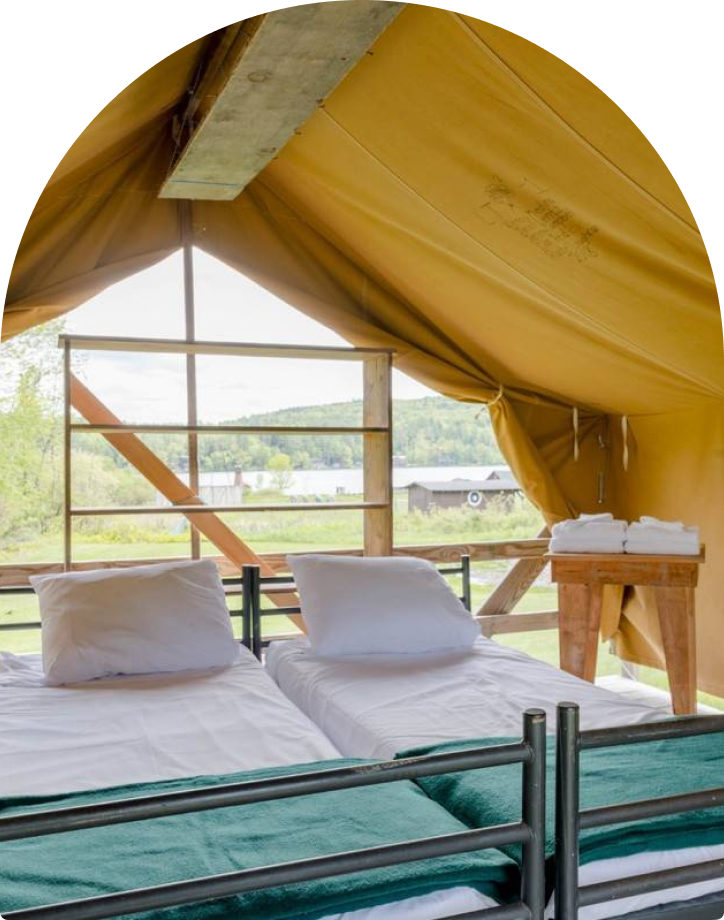 Two beds in a platform tent.