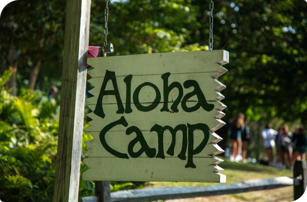 A sign that reads, "Aloha Camp".