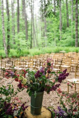 A vase of flowers at an outdoor wedding venue.