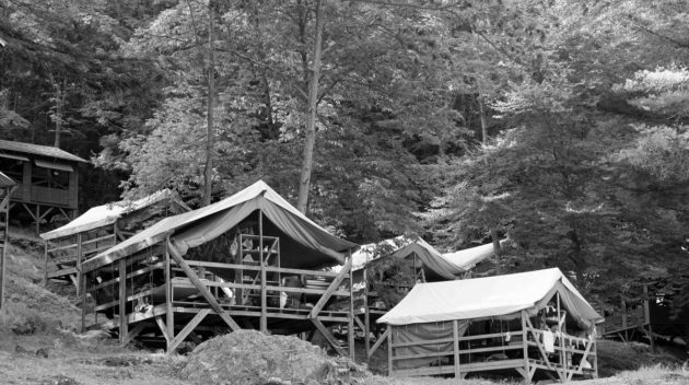 A black and white view of open air cabins.