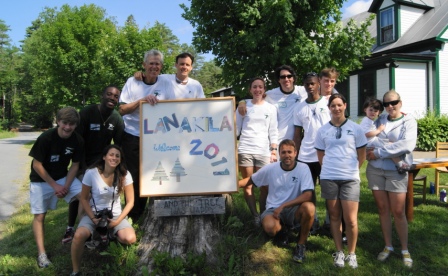 A group of Lanakila campers and counselors with the Lanakila 2011 sign by the main house.