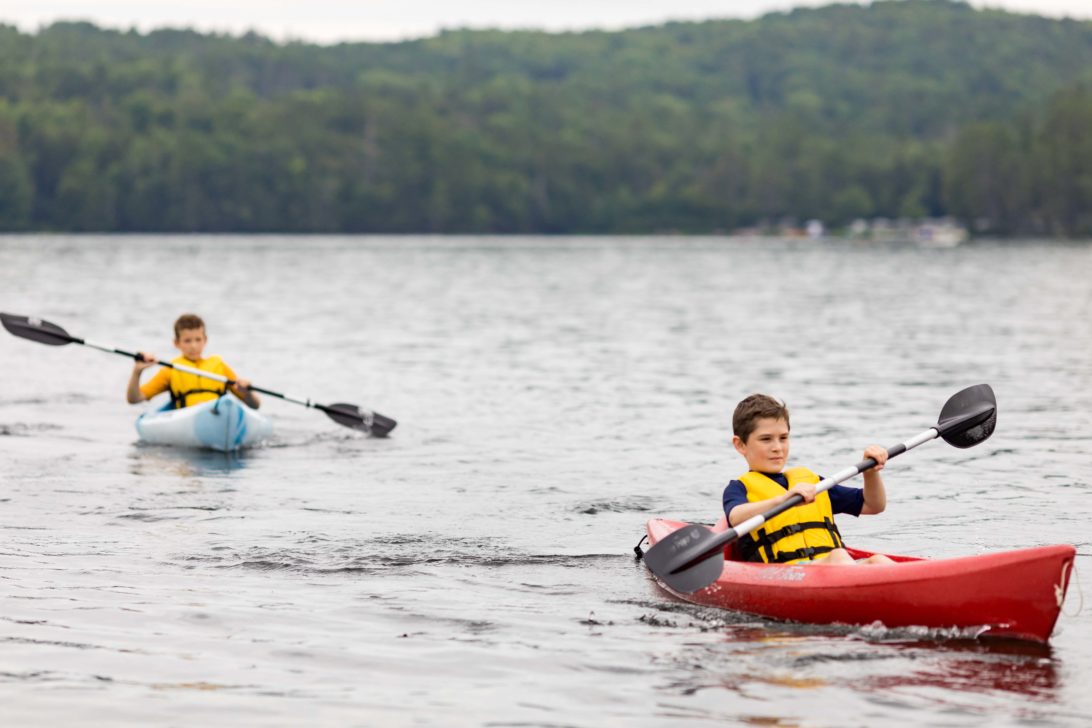 Two boys kayaking.
