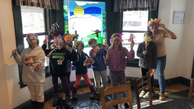 Campers posing with colorful masks.