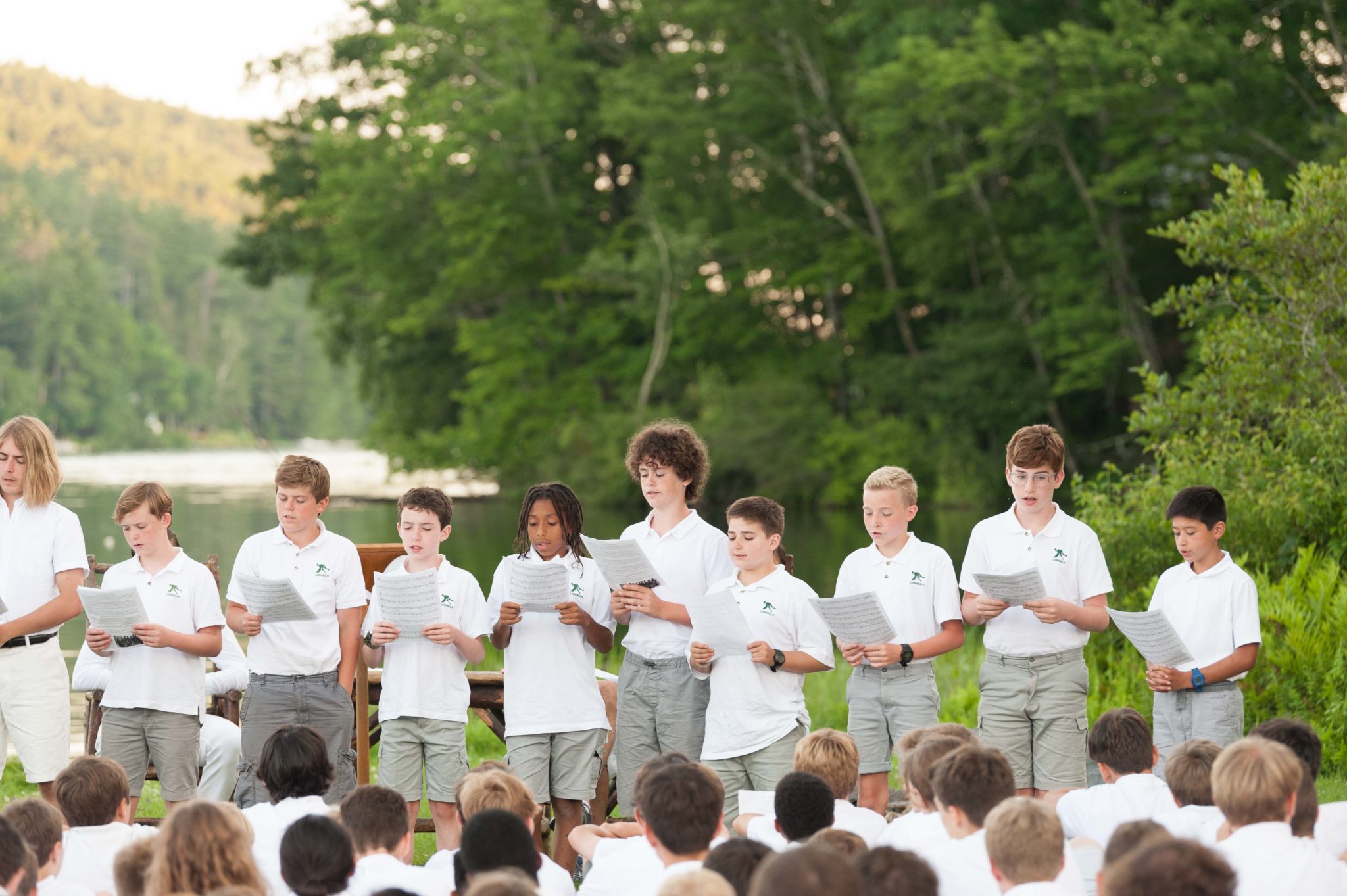 A group of campers at Lanakila singing at Lanakila during an outdoor assembly.