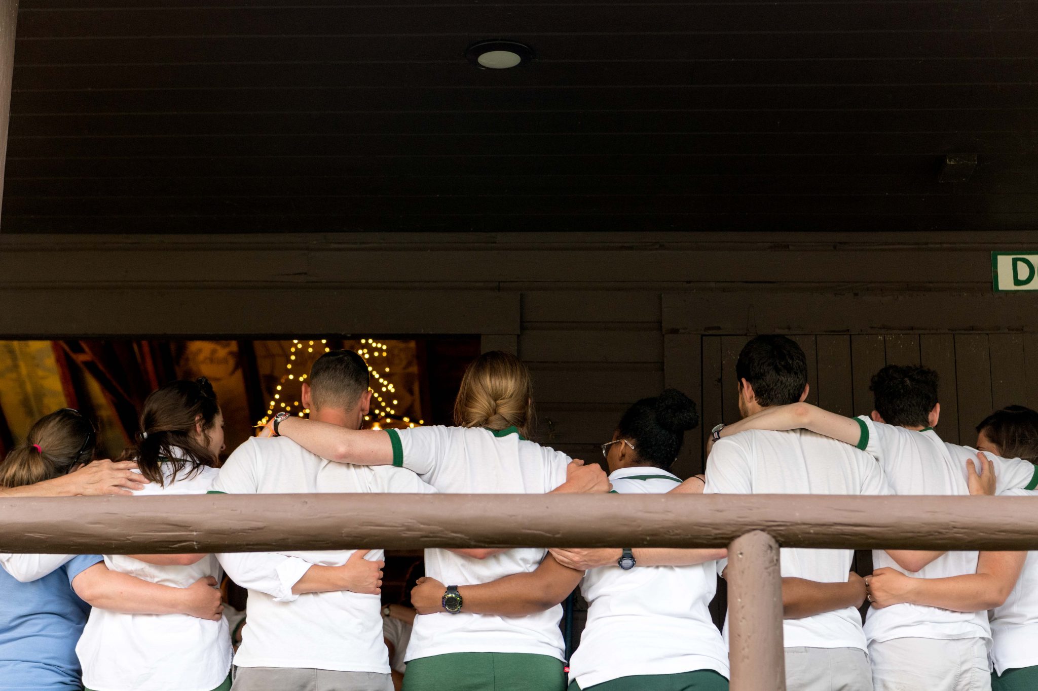 A group of folks from Aloha and Lanakila with their arms wrapped around each other.