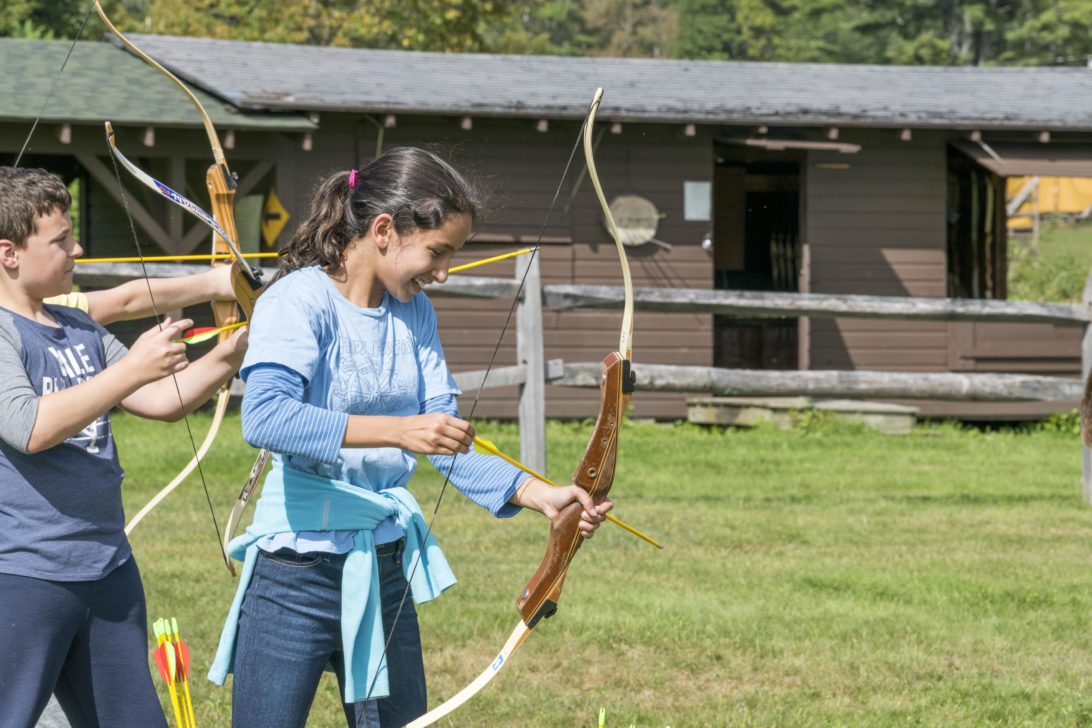 A child learning to shoot arrows at Hulbert.